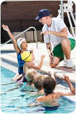 Counselor with campers in pool