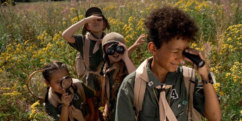 Children exploring outdoors at a summer camp