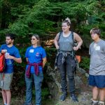 Summer camp staff members gathered outdoors during staff training
