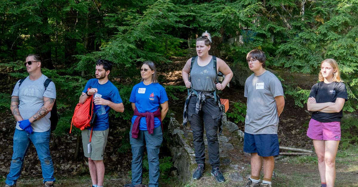 Summer camp staff members gathered outdoors during staff training